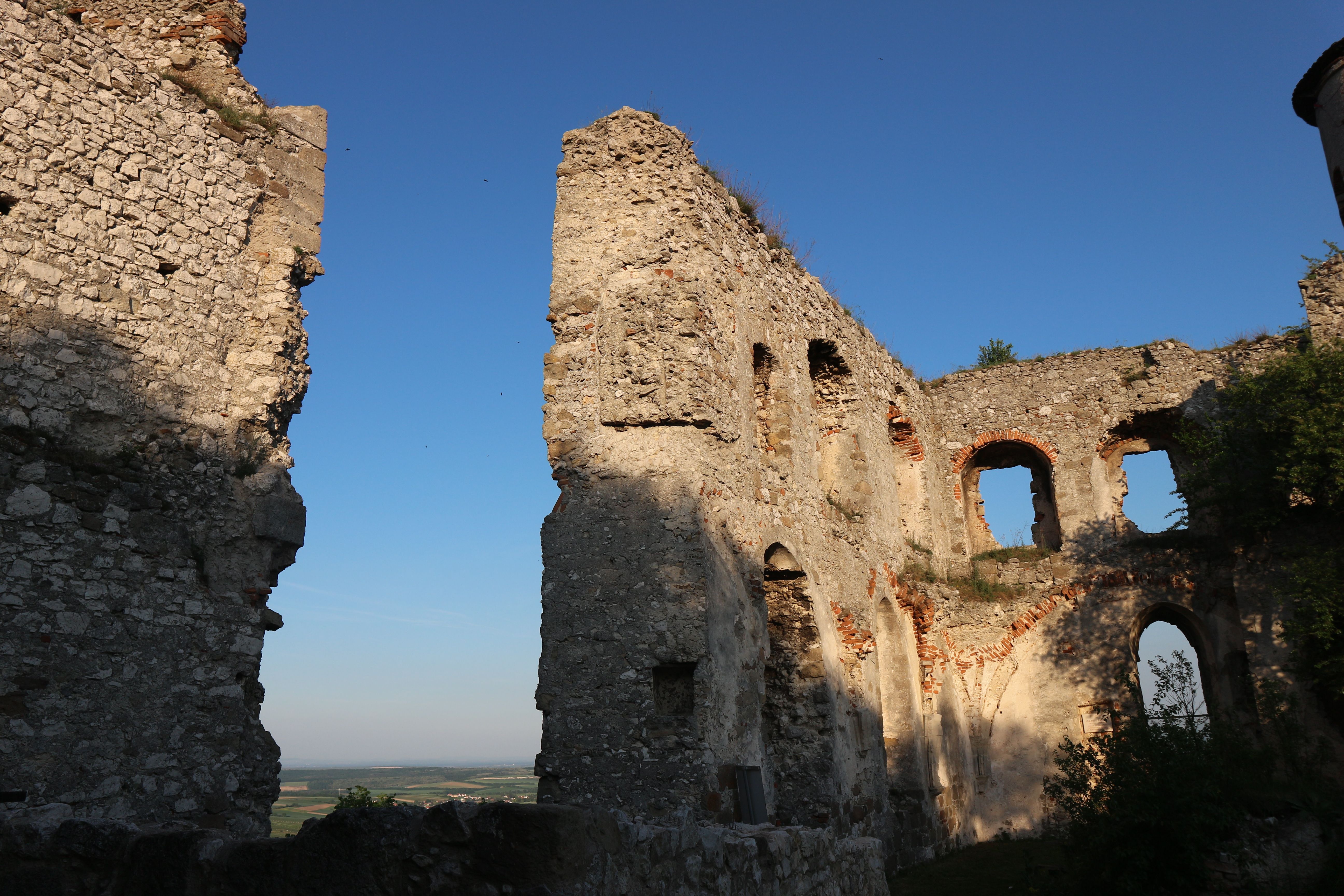 Ruins of the Falkenstein castle ruins at sunset with a blue sky.