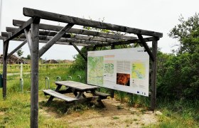 Cyclists' rest area with wooden table and information board on the Wine Road in the Weinviertel.