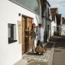 Two people enter a building labeled 'Hagn Weingut & Chalet'.