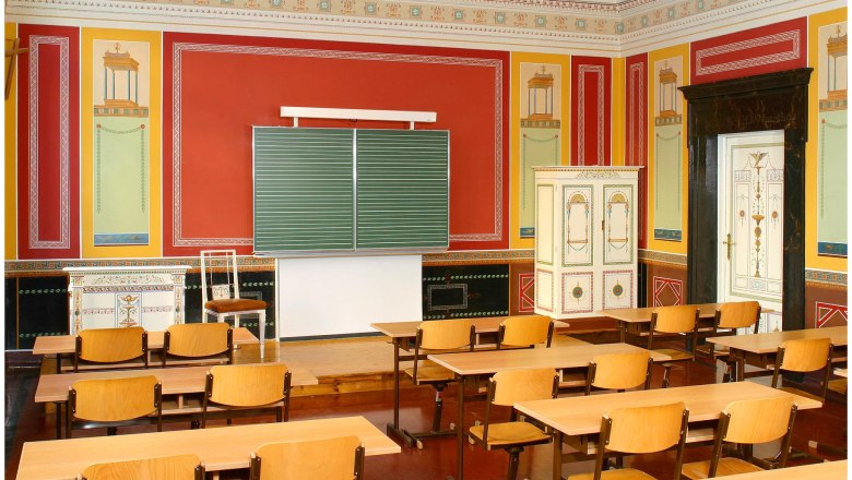 Classroom in Berndorf style with antique decor and wooden furniture.