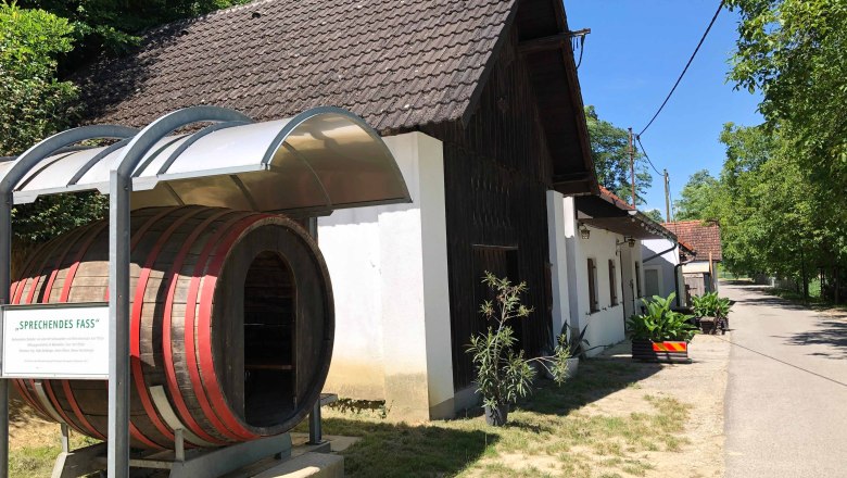 Wine tavern with large barrel and covered entrance.