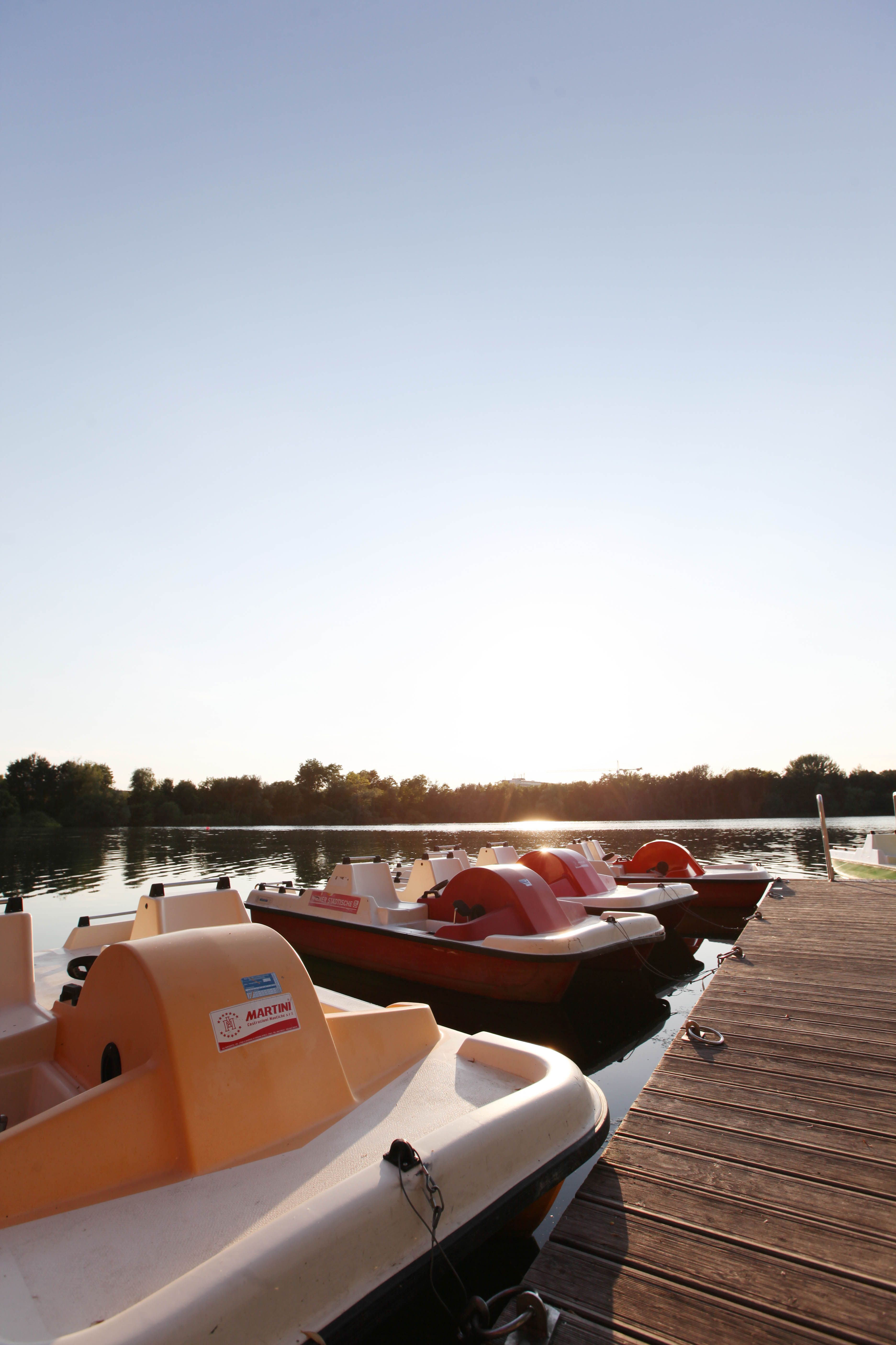 Pedal boats on the jetty at sunset.