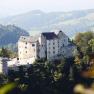 Plankenstein Castle on a hill with surrounding woods and hills in the background.