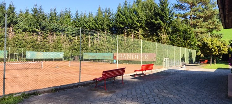 Tennis court with red clay and benches in Bad Sch&ouml;nau.