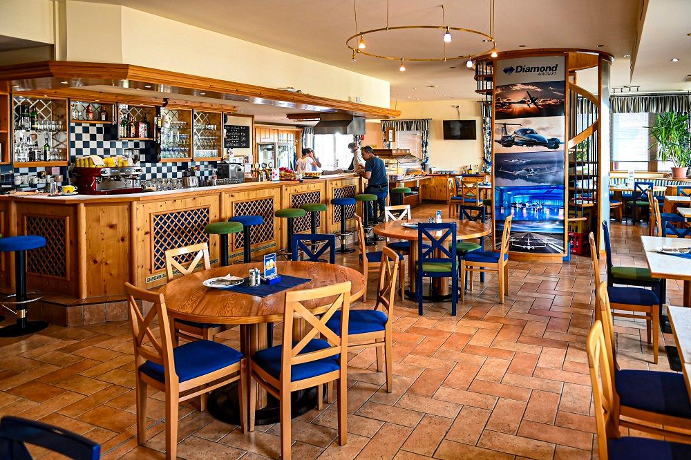 Interior view of a cozy pub with wooden furniture and bar area.