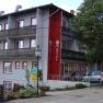Exterior view of the Hotel Thier with balconies and red lettering.