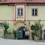 Historic building with archway and red bricks.