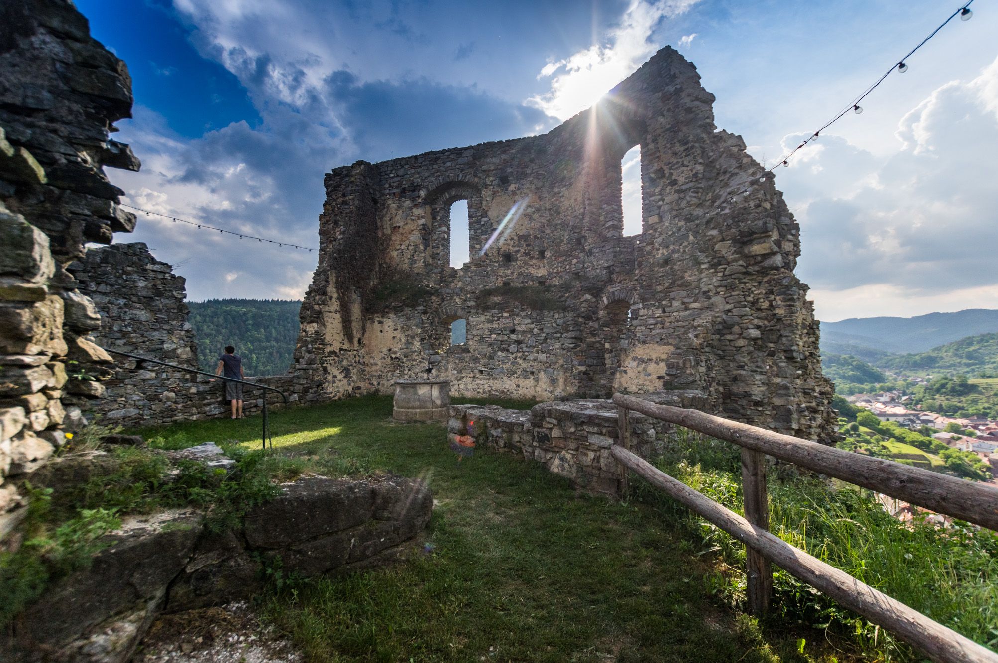 Ruin of Senftenberg Castle with sunbeams and landscape in the background.