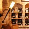 Wine bottles in a rustic cellar shelf made of bricks.
