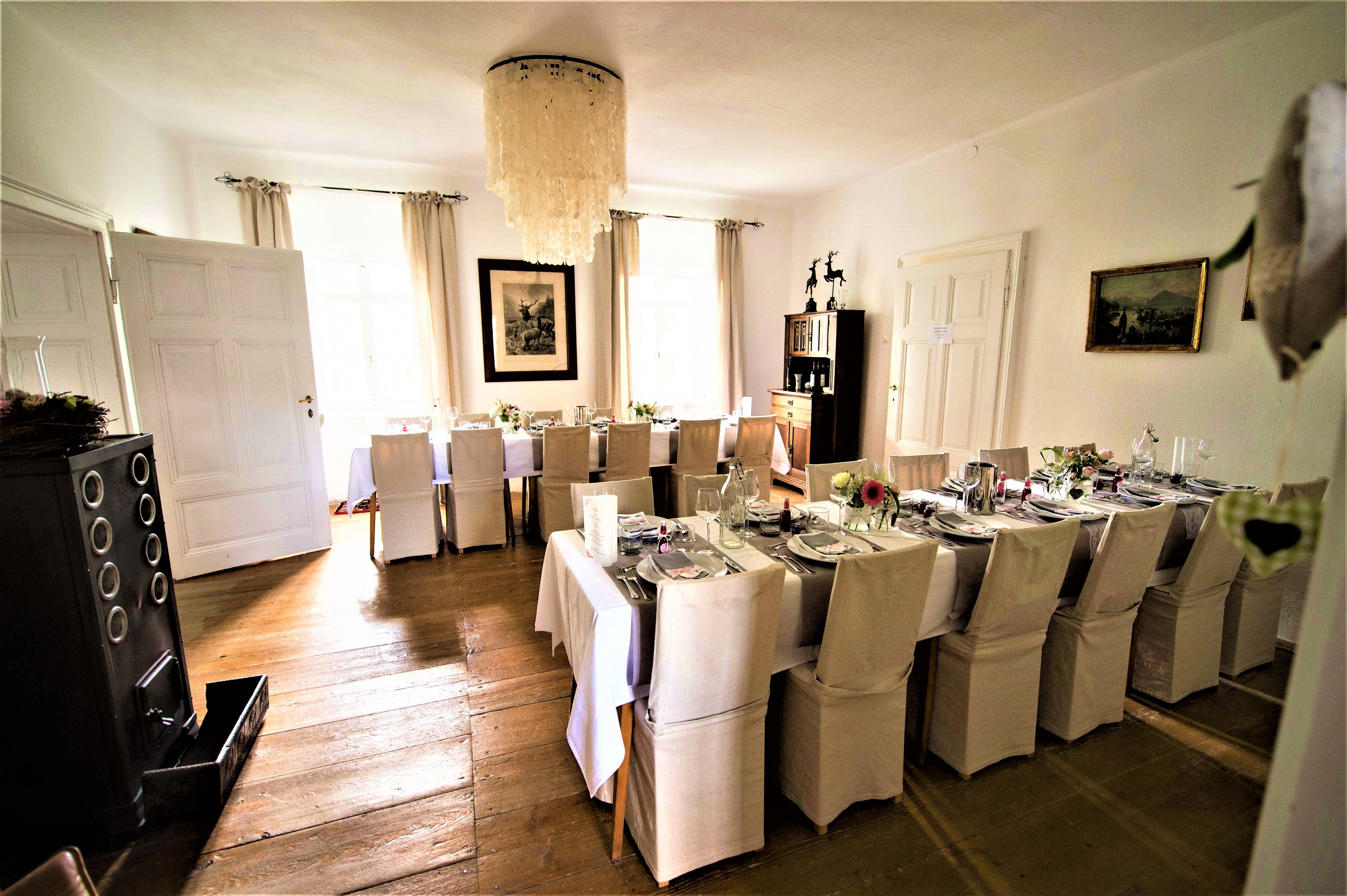 Elegant dining room with table setting and chandelier.