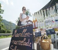 A stall selling apricot jam and schnapps on a street.