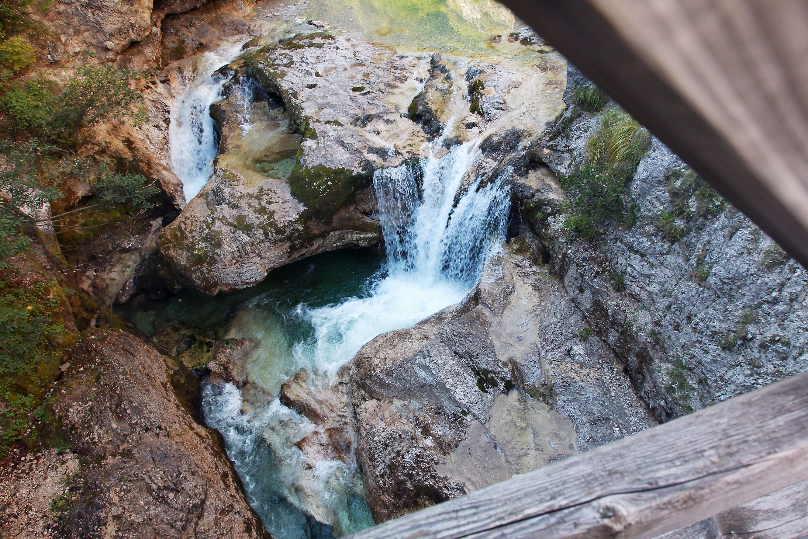 View from above of a waterfall in a rocky gorge.