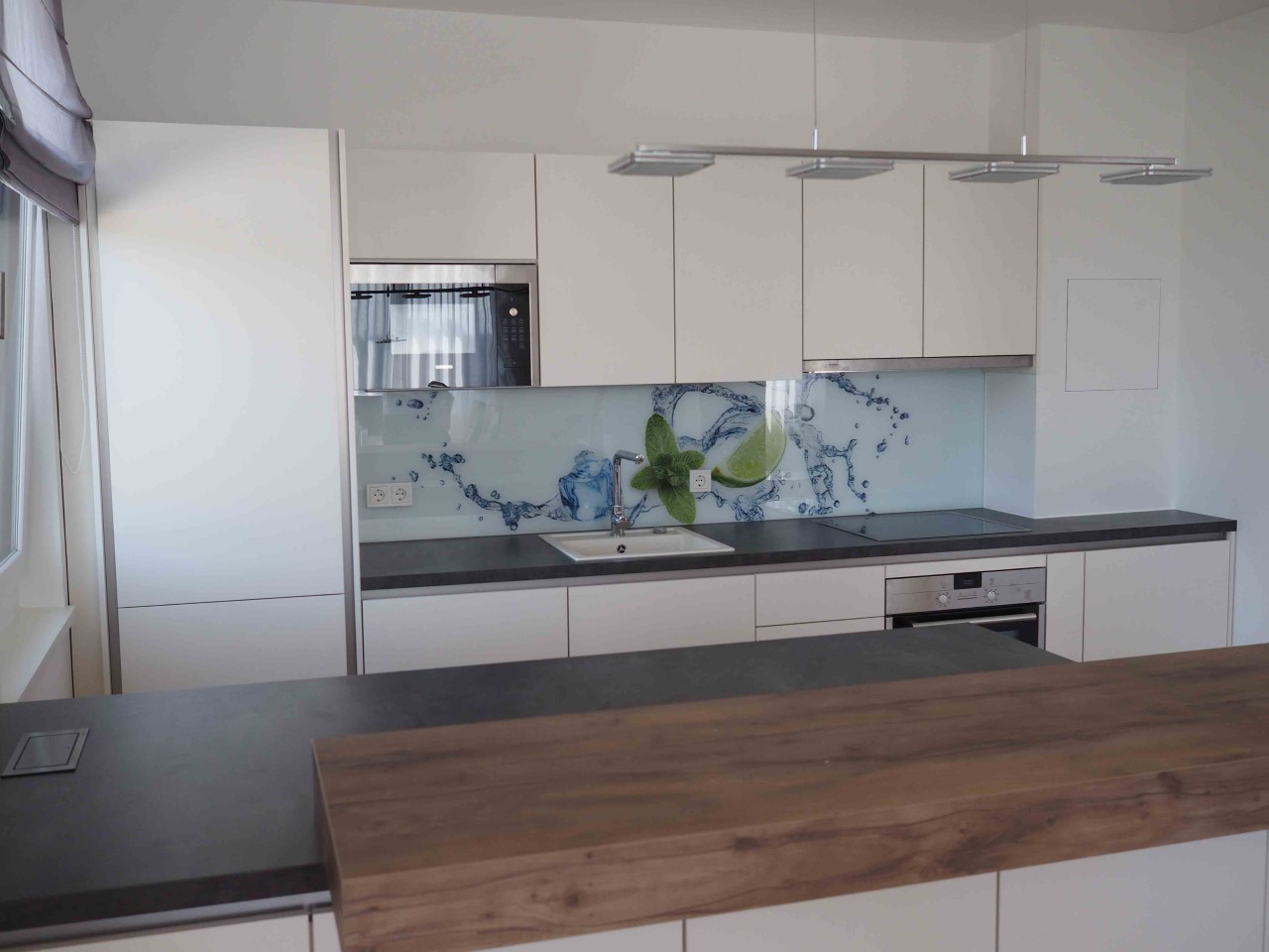 A modern kitchen unit in white and natural wood