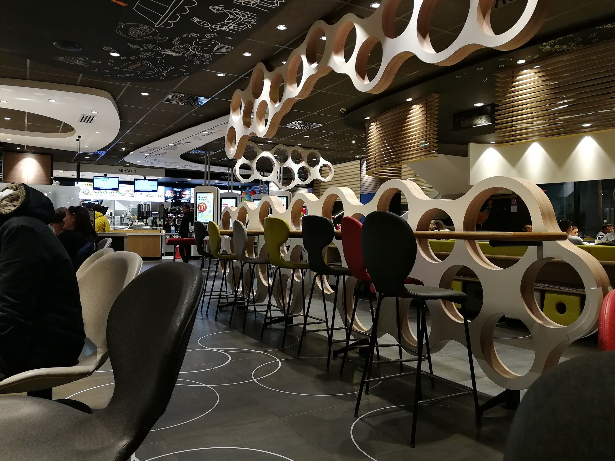 Interior view of a McDonald's restaurant with modern furniture and decorations.