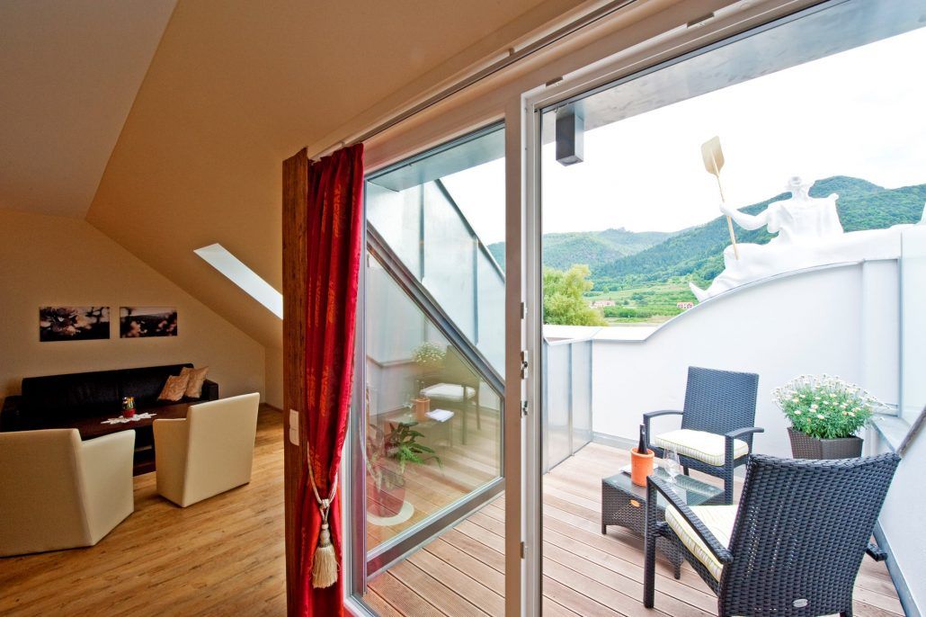 Interior view of a suite with balcony at Gasthof Prankl, view of the mountains.