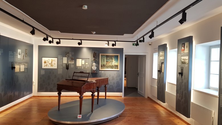 Exhibition room in Haydn's birthplace with historical piano and information boards.