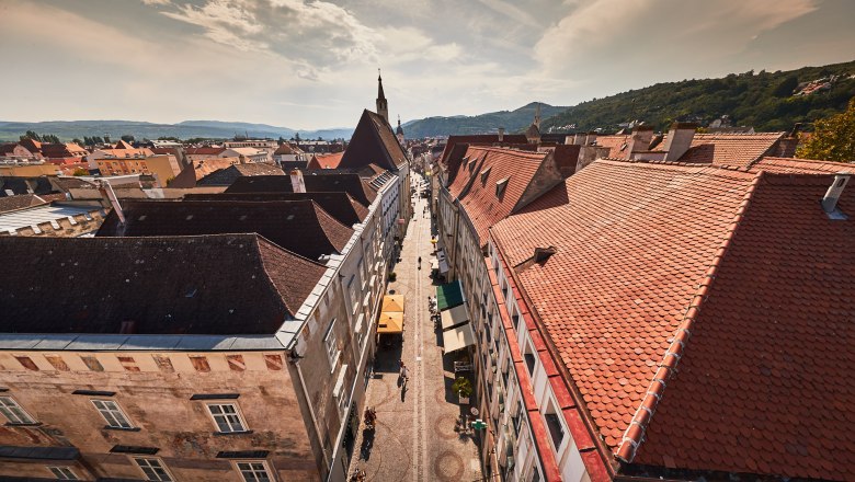 Aerial view of the old town of Krems with red tiled roofs and a central street.