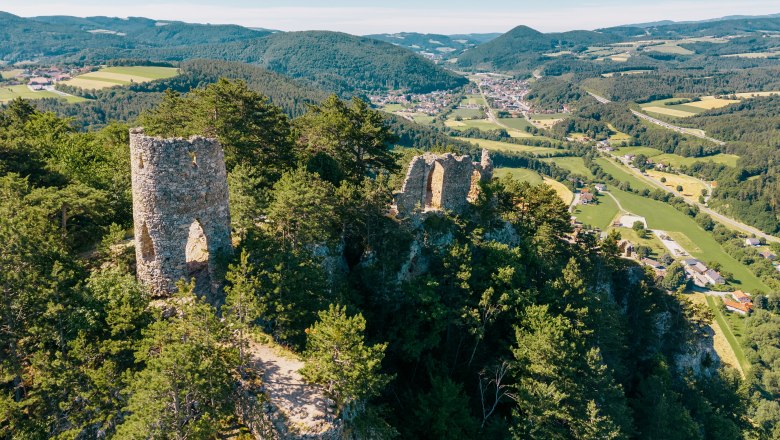 Aerial view of the Türkensturz ruins amidst wooded hills and green valleys.