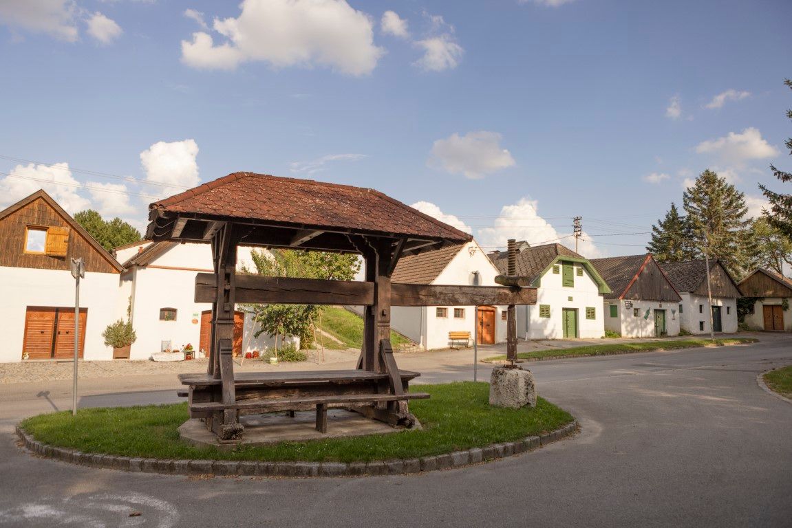 Historic wine press in Kettlasbrunn in front of traditional cellar lane houses.