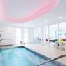Modern wellness area with a small pool, plants and a peaceful atmosphere.