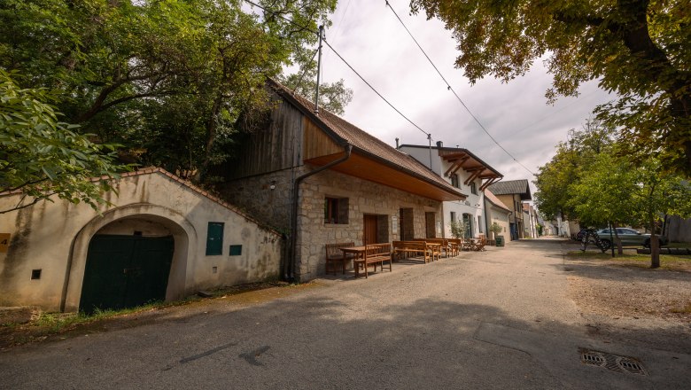 Weinviertler Kellerst&ouml;ckl with rustic buildings and trees.