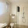 Modern bathroom with shower, toilet and washbasin.