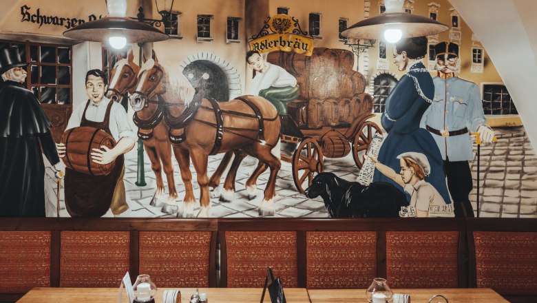 Wall painting in an inn with historical scenes of beer delivery by horse-drawn carriage.