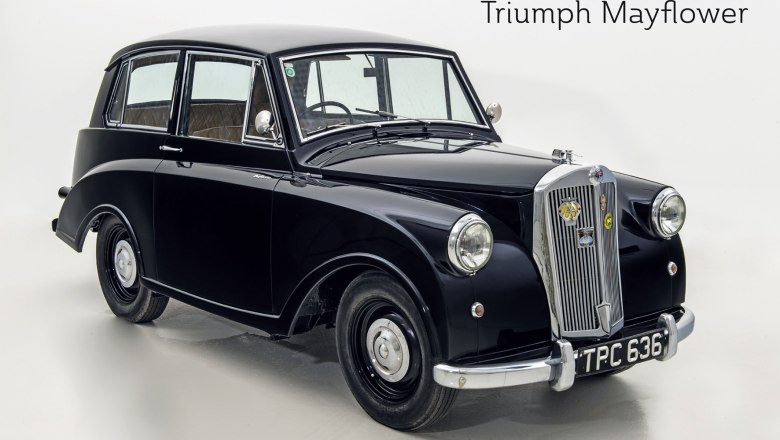 A black Triumph Mayflower vintage car against a white background.