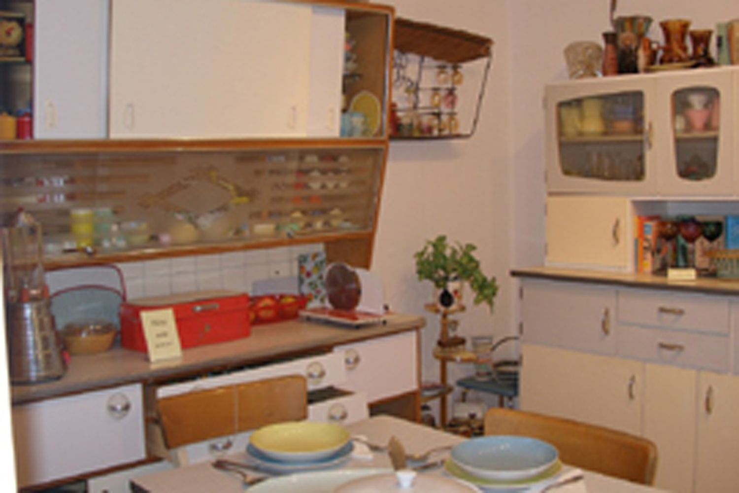 Interior view of a kitchen museum with retro furniture and crockery.