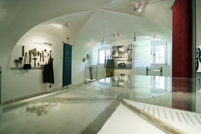 Interior view of a museum with tools and historical photos.