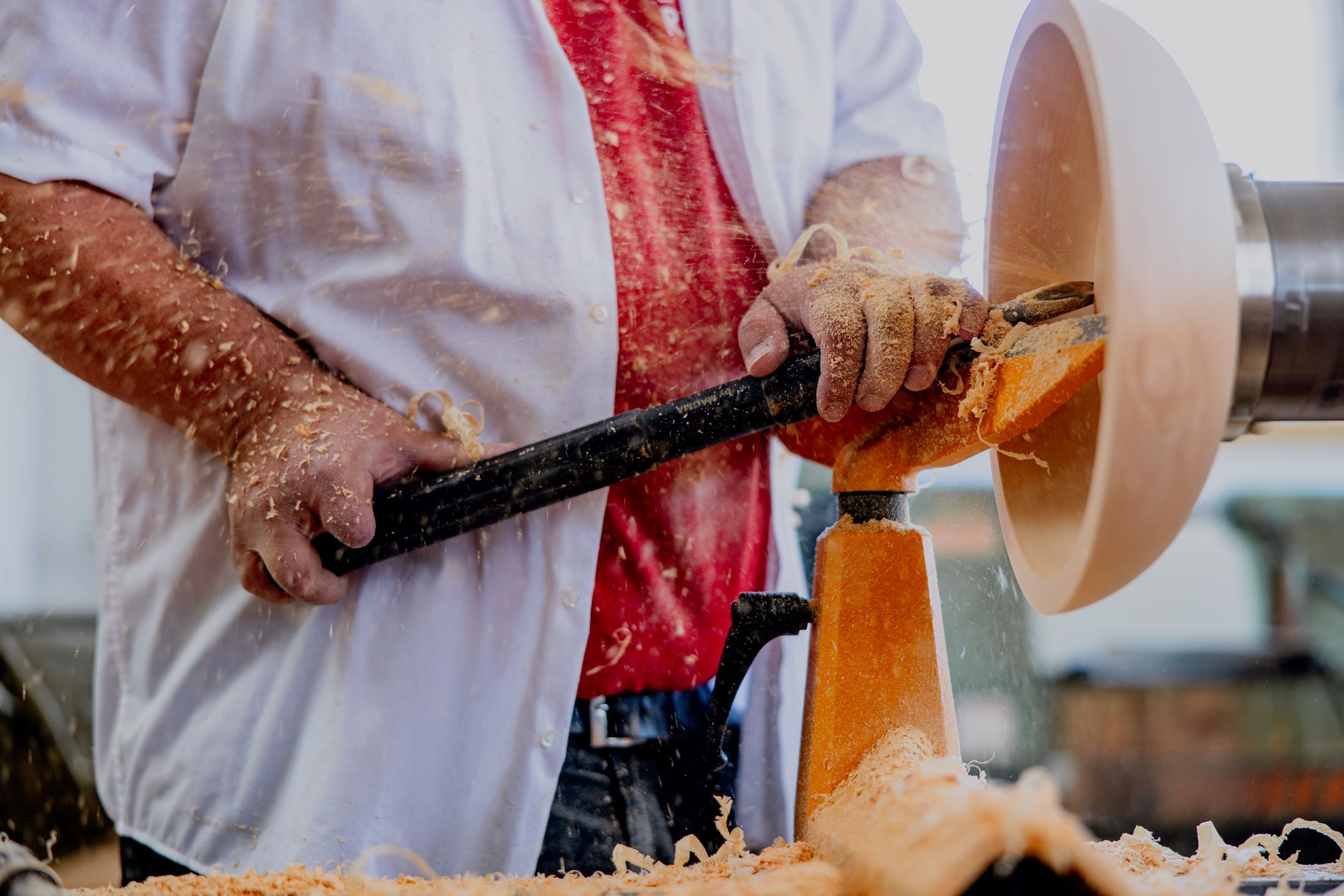 Person turning wood on a wood lathe.
