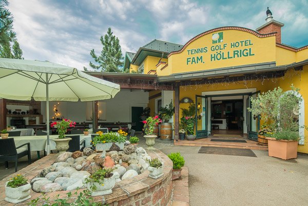 Entrance to the Tennis Golf Hotel Höllrigl with terrace and plants.