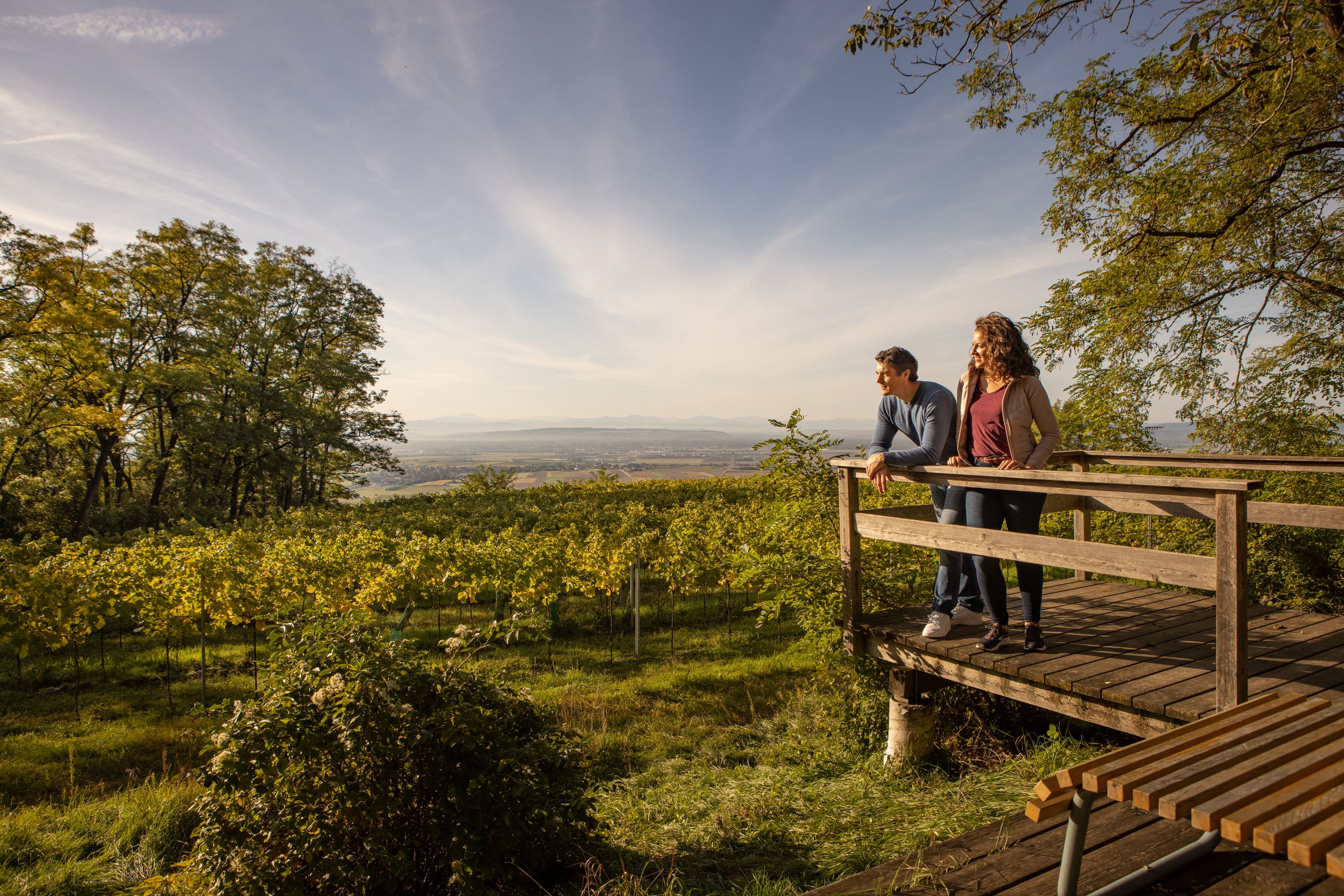 Couple on viewing platform with view of vineyards