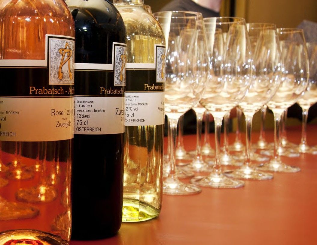 Wine bottles and glasses on a table.