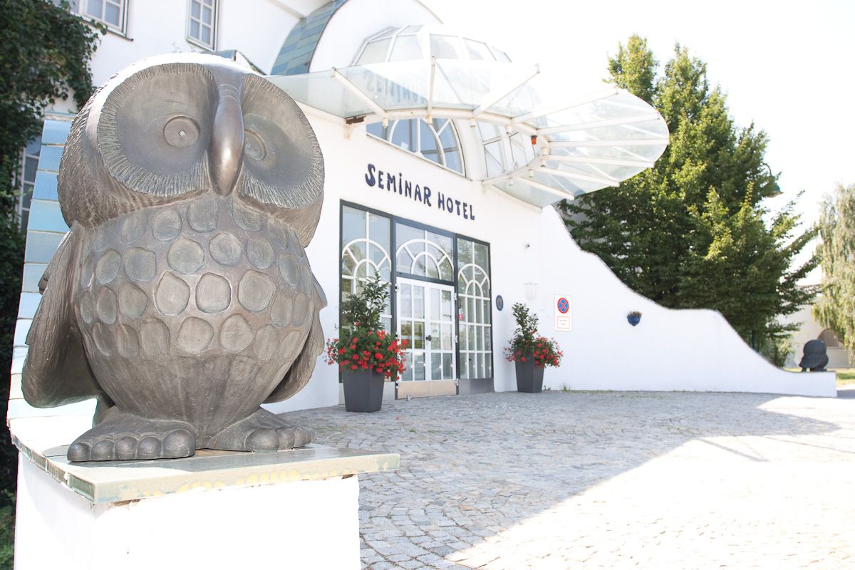 Entrance to a seminar hotel with owl sculpture.