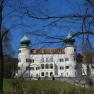 Artstetten Castle with two striking towers and blue sky in the background.