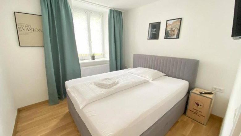 Double room with wooden floor and large window