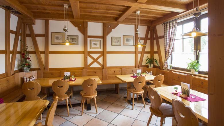 Interior view of a traditional wine tavern with wooden furniture and decoration.