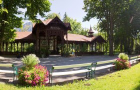 A pavilion in the spa gardens, surrounded by trees and flowers