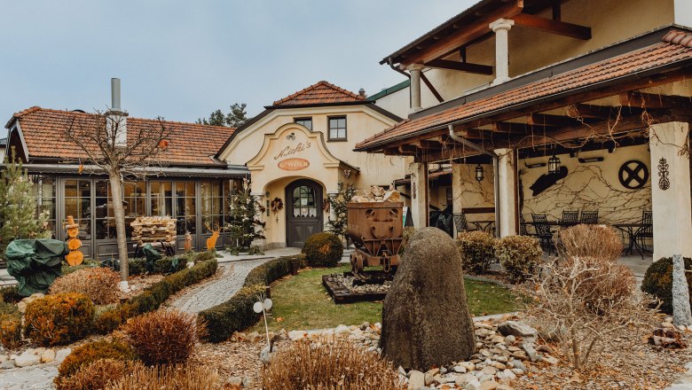 Exterior view of a traditional inn with garden and decorations.