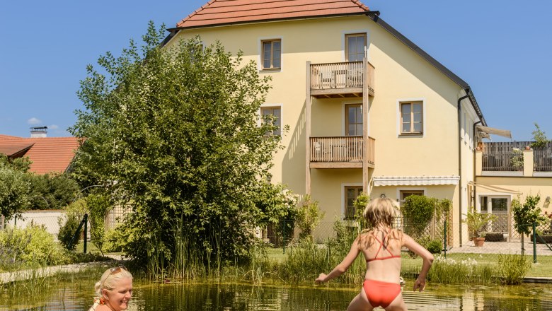 A woman and two children at the bathing pond in the ad vineas guest house