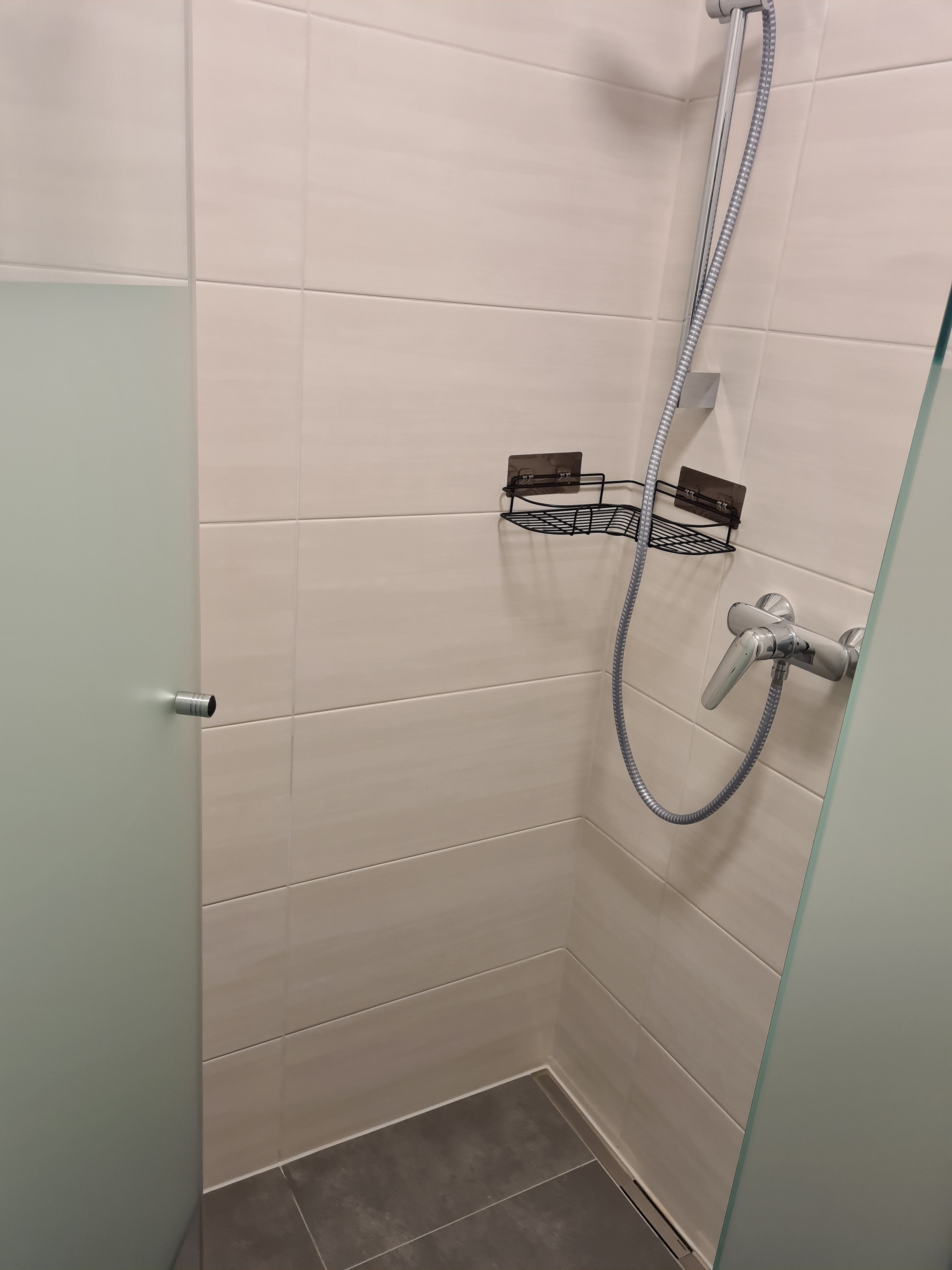 Modern shower with glass wall and shower head.
