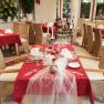 Elegant restaurant with red tablecloths and laid tables.