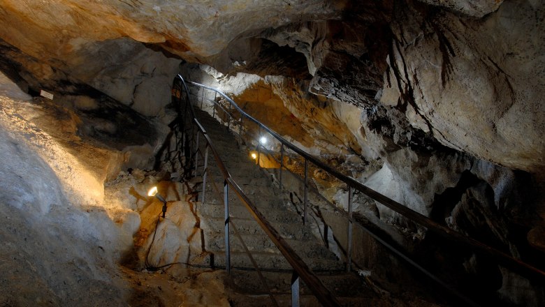 Interior view of the Nix Cave in Frankenfels with illuminated staircase.