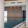 Interior view of an infinity pool at the Hotel Schachner with wooden cladding and modern columns.
