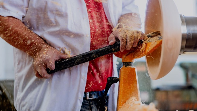 Person turning wood on a lathe.
