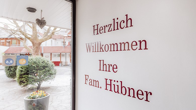 Entrance area with welcome text on the wall and view outside.