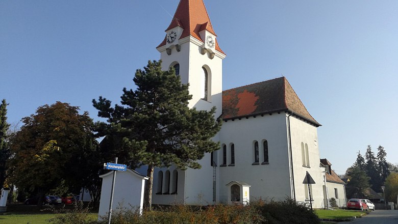 Droß parish and pilgrimage church with red roof and clock tower.