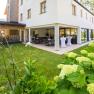 Exterior view of a modern hotel with terrace and garden.