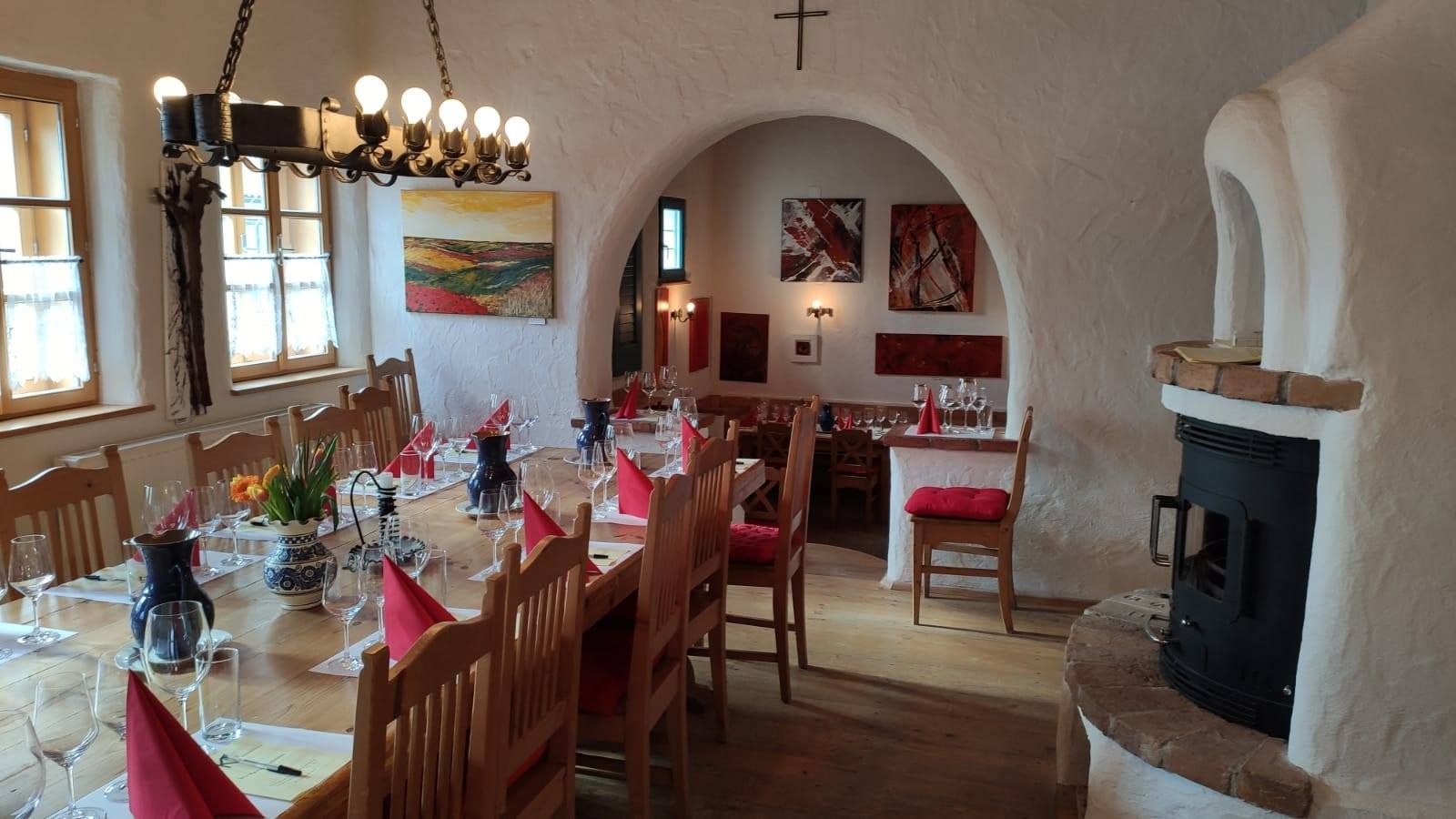 Cozy room with table setting, wine glasses and fireplace.